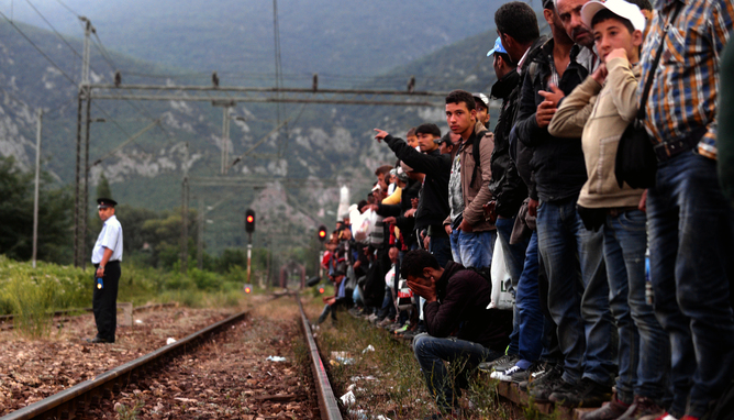 Refugees wait for a train to Serbia on a track near a train station in Demi Kapija, Former Yugoslav Republic of Macedonia EPA/NAKE BATEV